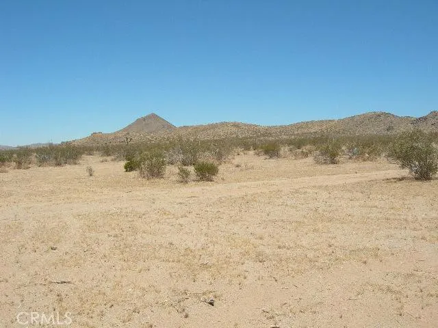 a view of ocean with a mountain in the background