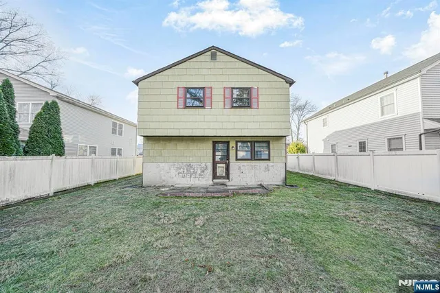 a view of a house with a yard and a garage