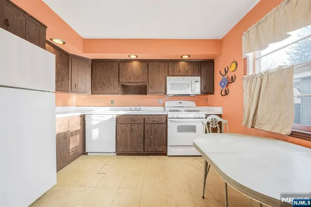 a kitchen with a stove a sink and a refrigerator