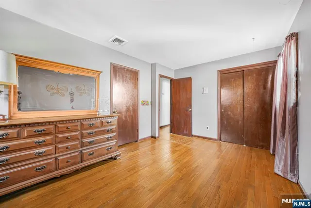a view of room with window and wooden floor