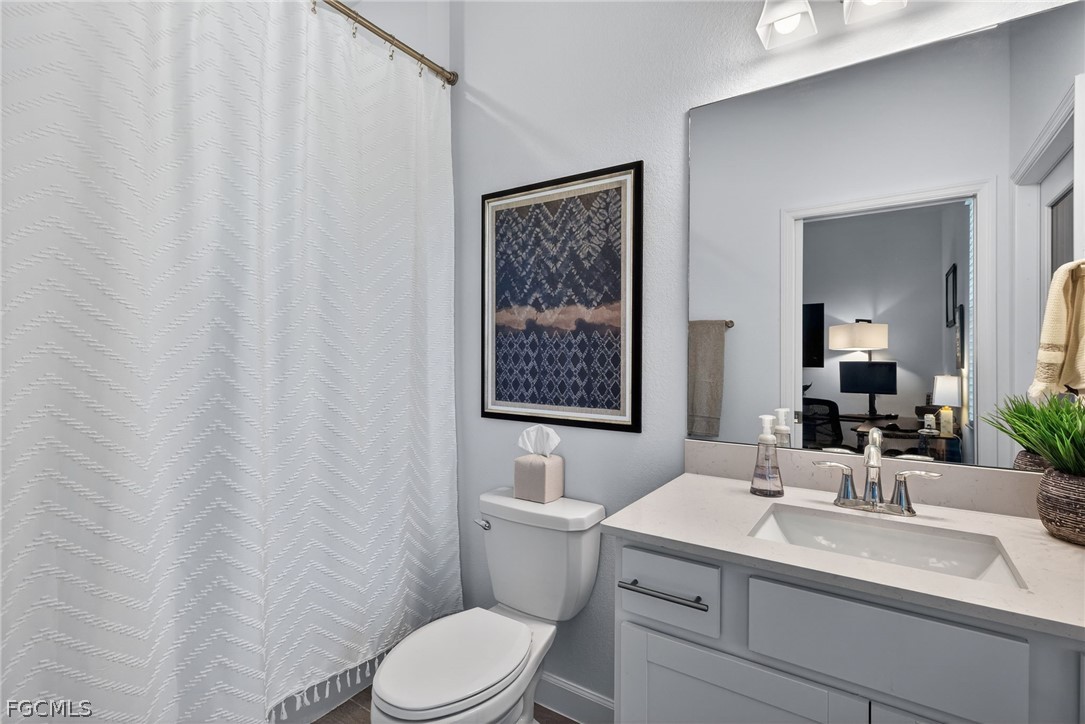 14598 Lagoon Drive Punta Gorda, FL 33982 - Photo 16 of 46 a bathroom with a toilet sink and mirror