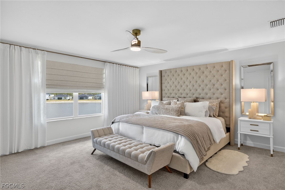 14598 Lagoon Drive Punta Gorda, FL 33982 - Photo 23 of 46 a bedroom with a bed and a chandelier