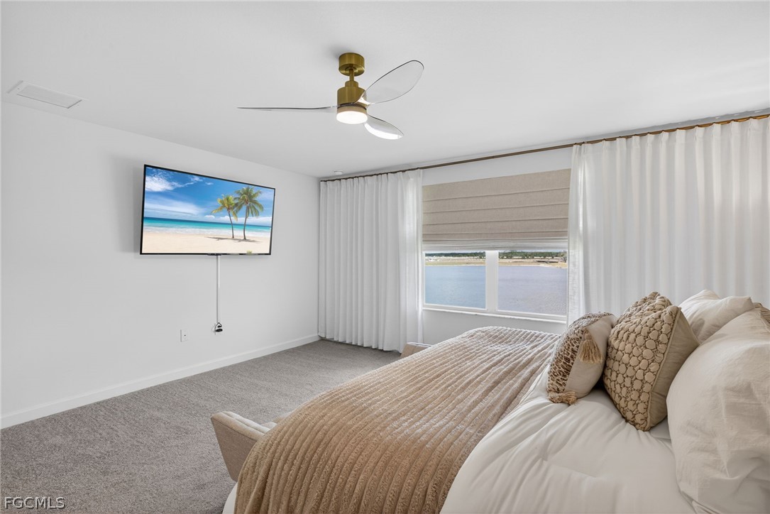 14598 Lagoon Drive Punta Gorda, FL 33982 - Photo 25 of 46 a bedroom with a large bed and a window