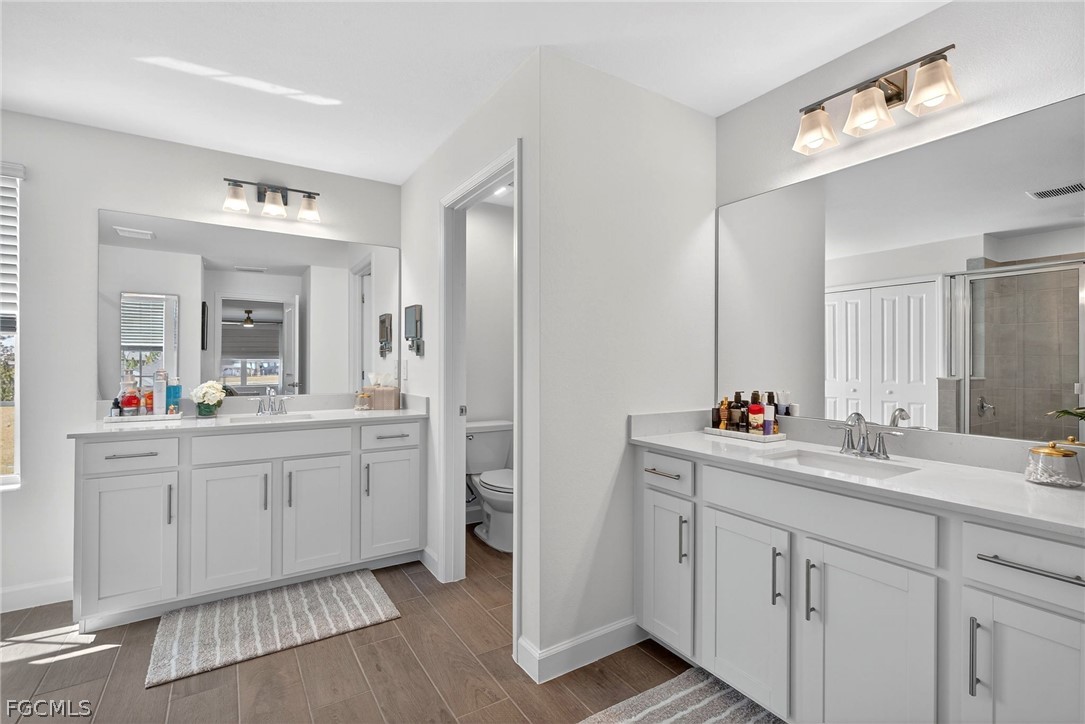 14598 Lagoon Drive Punta Gorda, FL 33982 - Photo 27 of 46 a en suite bathroom with double sink and a mirror