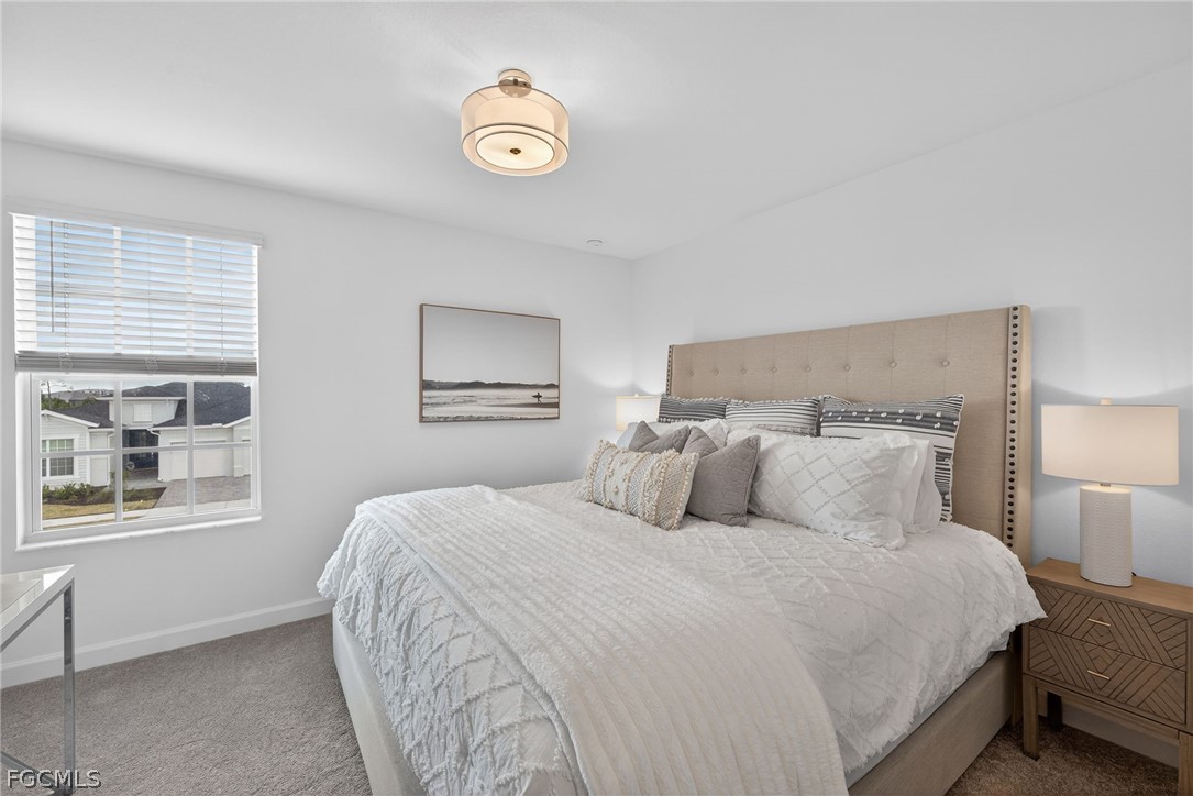 14598 Lagoon Drive Punta Gorda, FL 33982 - Photo 29 of 46 a bedroom with a bed and a window