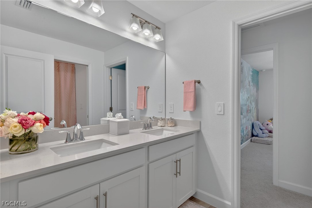 14598 Lagoon Drive Punta Gorda, FL 33982 - Photo 34 of 46 a bathroom with a sink double vanity and a mirror