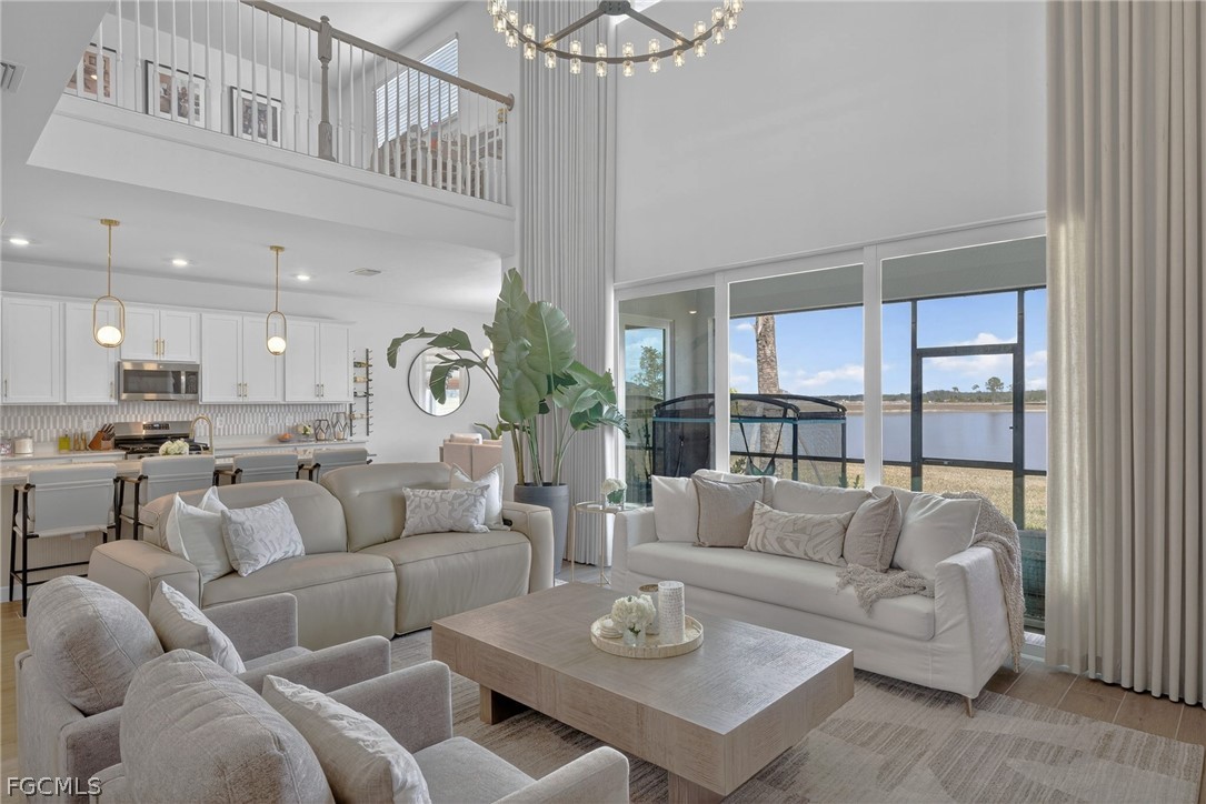 14598 Lagoon Drive Punta Gorda, FL 33982 - Photo 4 of 46 a living room with furniture kitchen view and a chandelier