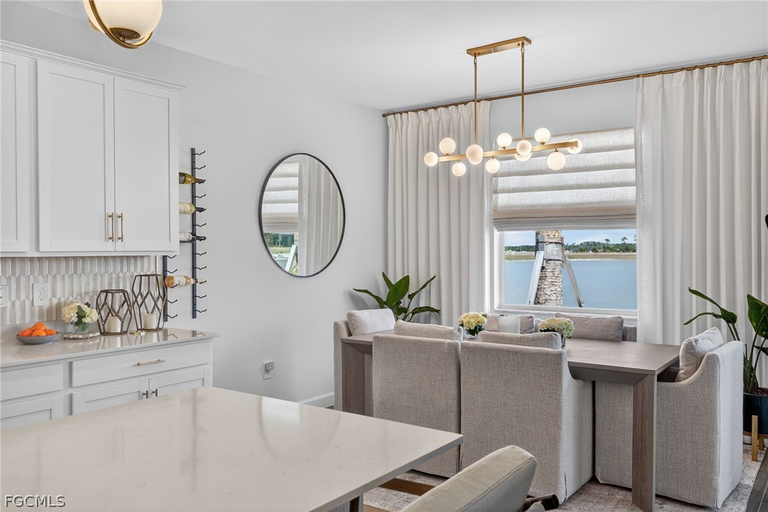 14598 Lagoon Drive Punta Gorda, FL 33982 - Photo 7 of 46 a workspace with a table chairs and a chandelier