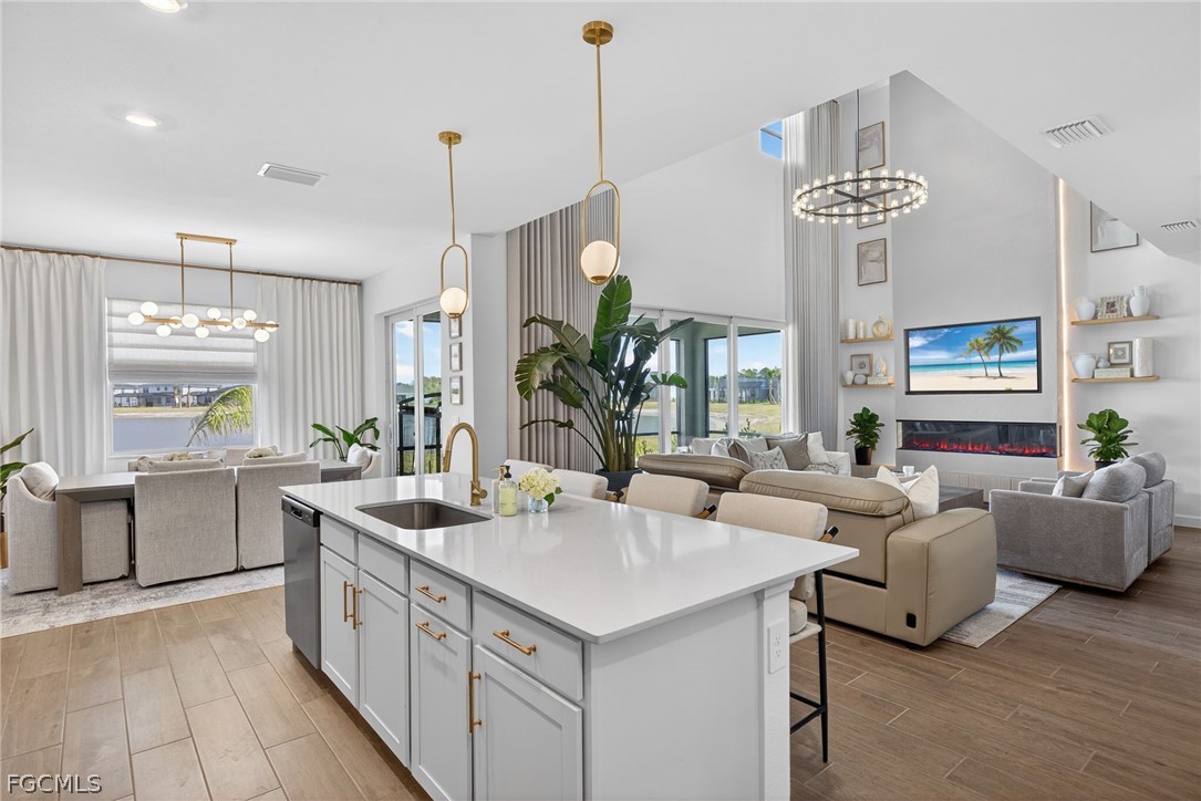 14598 Lagoon Drive Punta Gorda, FL 33982 - Photo 9 of 46 a very nice looking living room with a large dining table wooden floor and a chandelier