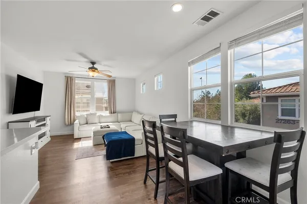 a view of a dining room with furniture window and wooden floor