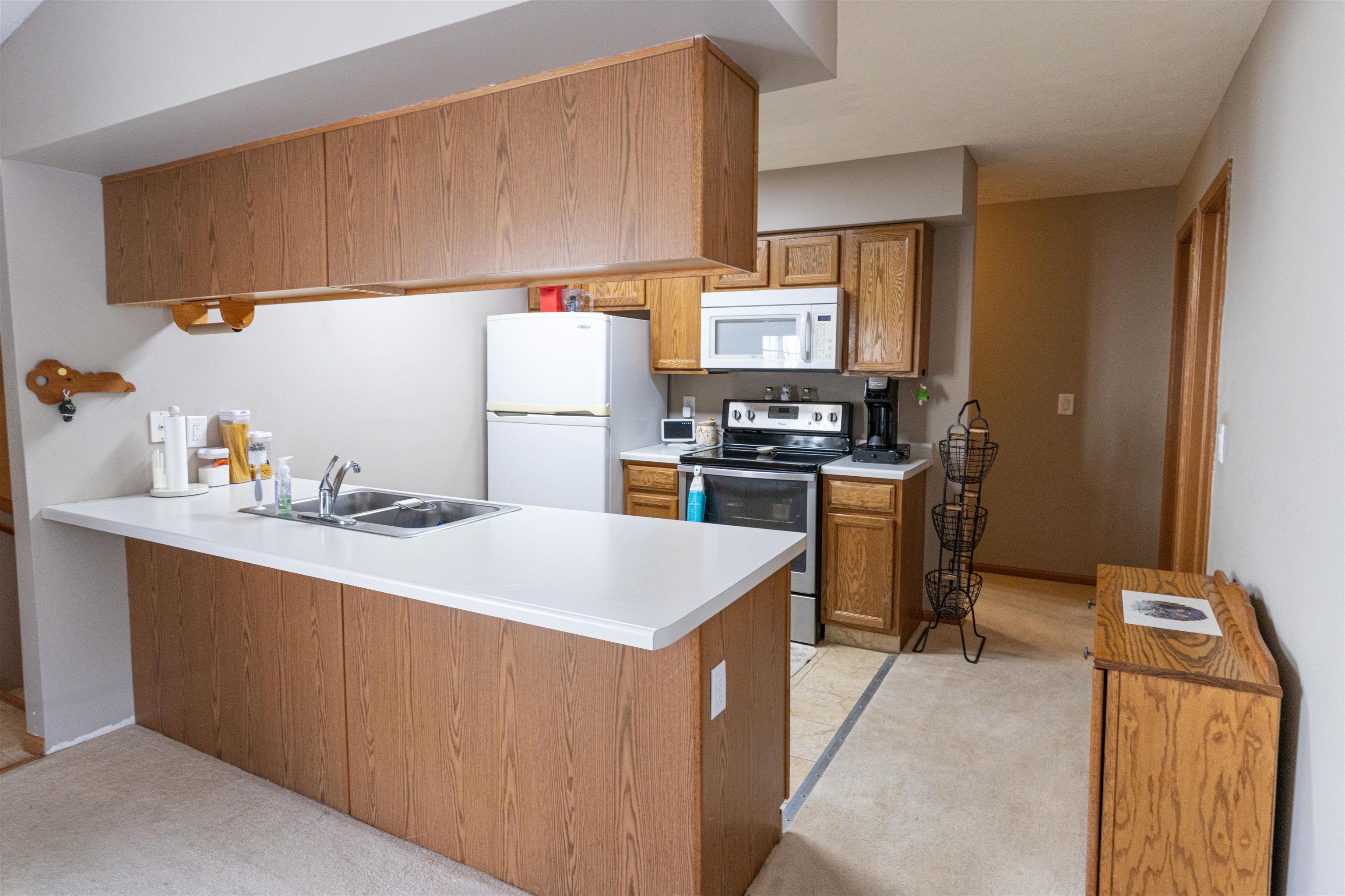 6502 Timberleaf Court Loves Park, IL 61111 - Photo 12 of 23 a kitchen with a sink a stove and a refrigerator