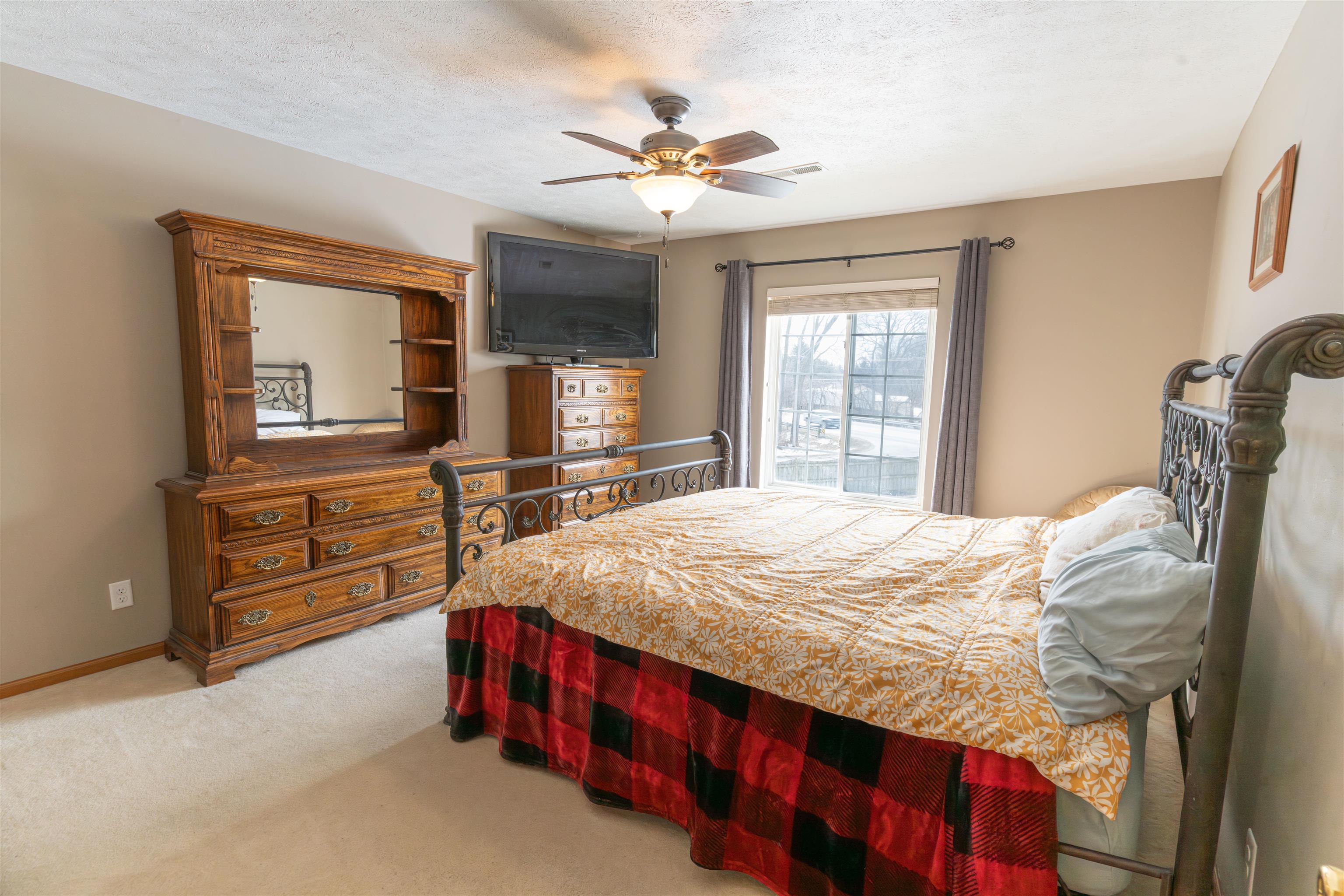 6502 Timberleaf Court Loves Park, IL 61111 - Photo 17 of 23 a bed sitting in a bedroom and dresser with wooden floor