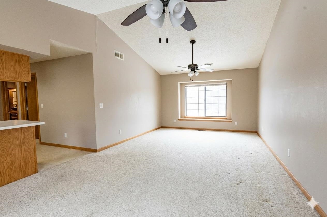 6502 Timberleaf Court Loves Park, IL 61111 - Photo 10 of 23 an empty room with windows and chandelier fan