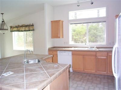 22613 East Side Road Willits, CA 95490 - Photo 4 of 9 a kitchen with a sink window and cabinets