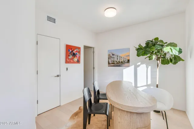 a view of a dining room with furniture and a potted plant