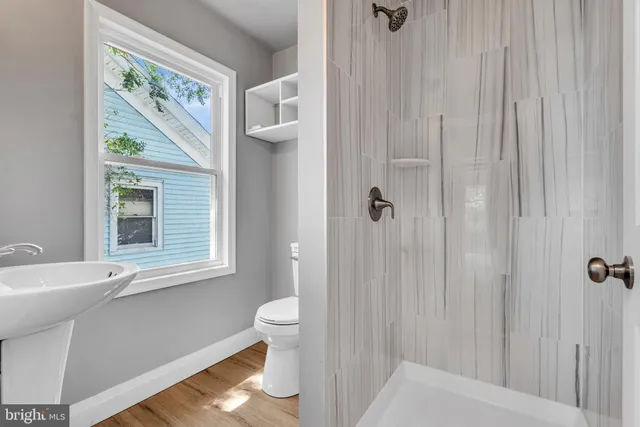 a bathroom with a toilet a sink and a window