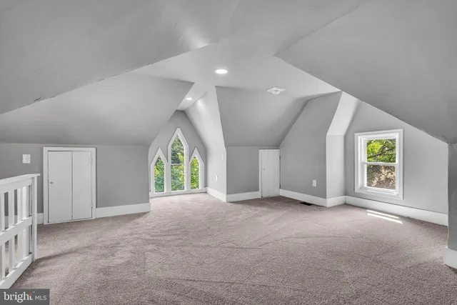 an empty room with windows and entrance