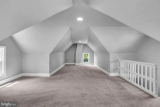 a view of empty room with windows and ceiling fan
