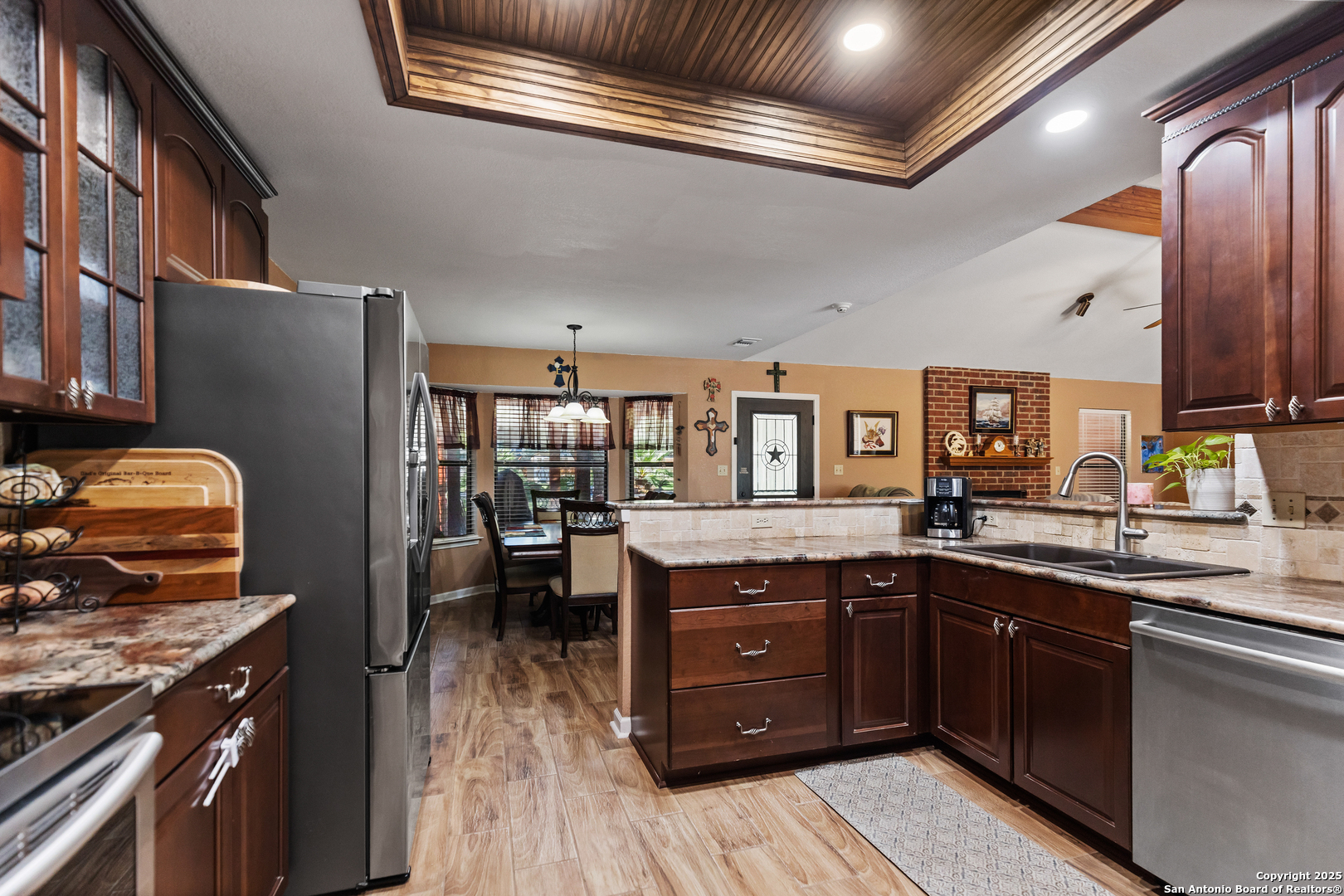 606 Ingram Road Devine, TX 78016 - Photo 12 of 36 a kitchen with stainless steel appliances granite countertop a sink and wooden cabinets