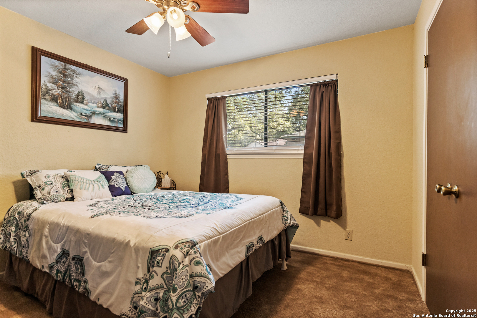 606 Ingram Road Devine, TX 78016 - Photo 16 of 36 a bedroom with a bed and a window