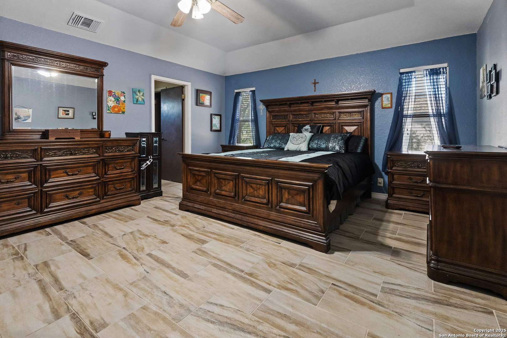606 Ingram Road Devine, TX 78016 - Photo 20 of 36 a bedroom with a bed and wooden floor