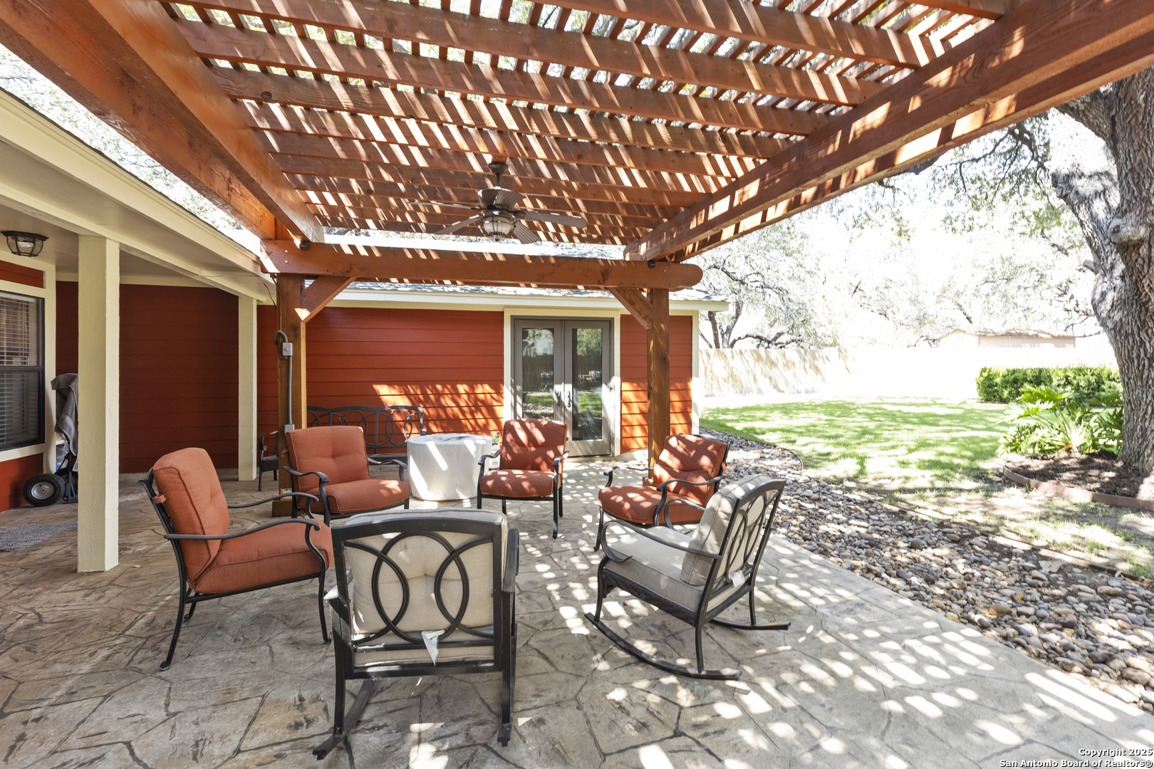 606 Ingram Road Devine, TX 78016 - Photo 33 of 36 a view of a patio with table and chairs and floor to ceiling window