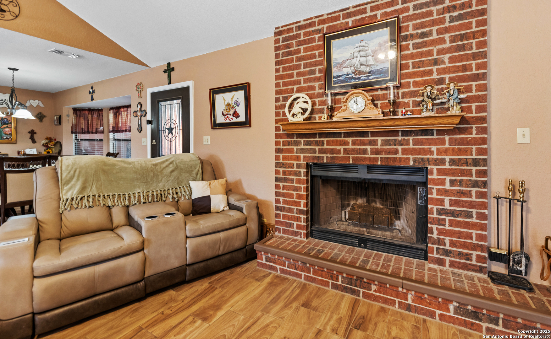 606 Ingram Road Devine, TX 78016 - Photo 8 of 36 a living room with furniture a fireplace and a flat screen tv