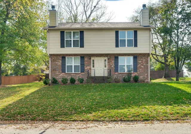 a spacious bedroom with a bed a chair and a large window