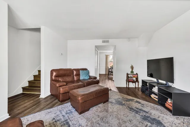 a living room with furniture large window and a fireplace