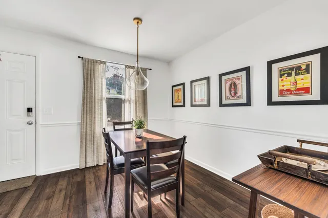 a kitchen with stainless steel appliances a dining table chairs and granite counter tops