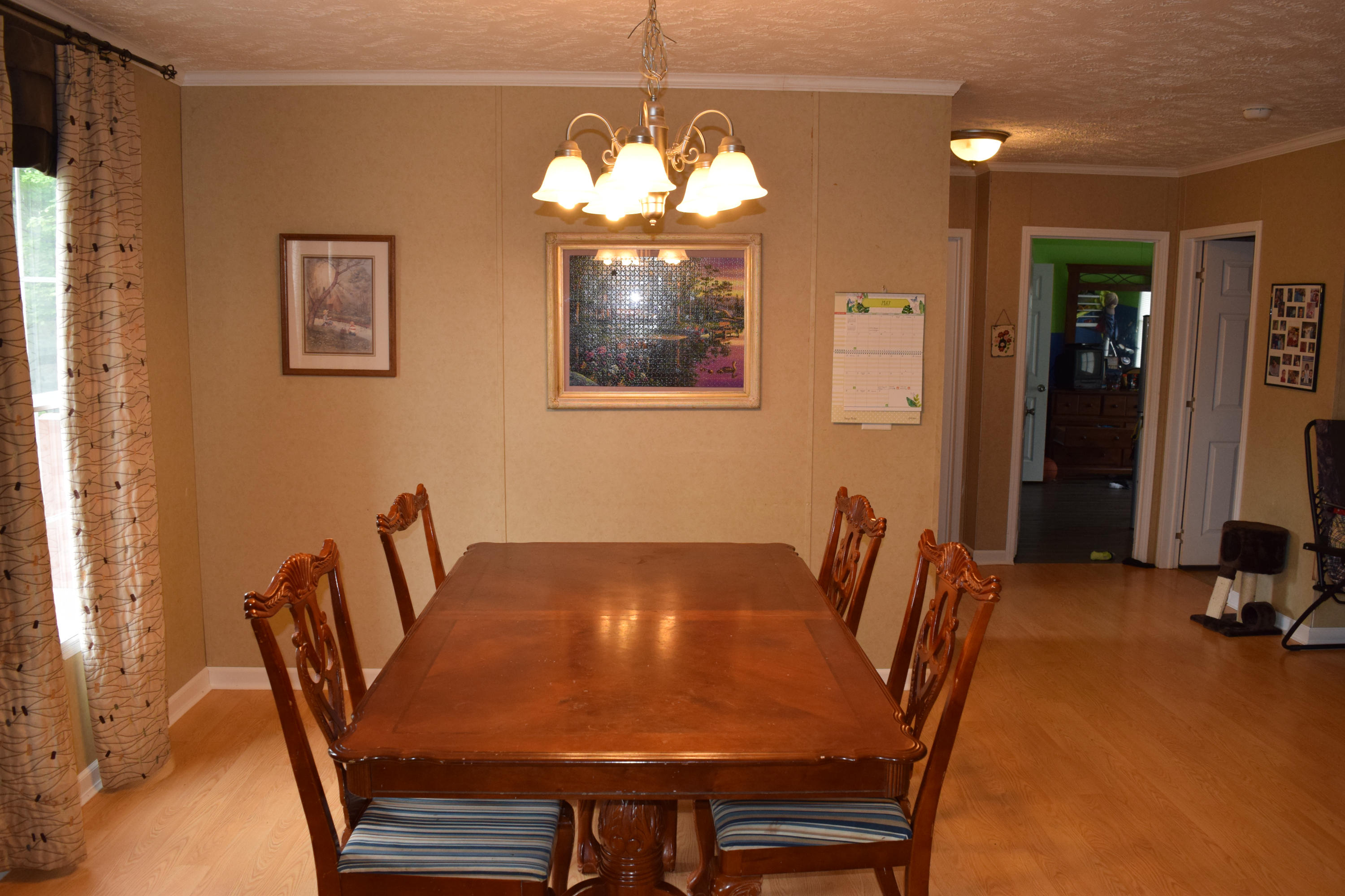 4752 Waidsboro Road Ferrum, VA 24088 - Photo 16 of 38 a view of a dining room with furniture and chandelier