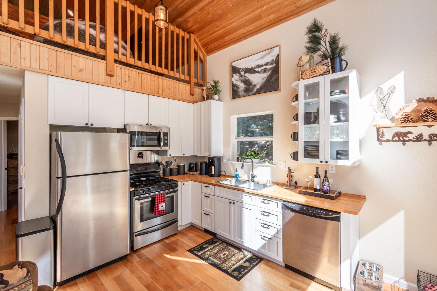 1070 Mountain View Road Arnold, CA 95223 - Photo 62 of 99 a kitchen with stainless steel appliances a refrigerator a sink a stove and white cabinets
