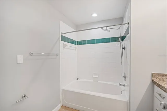 a bathroom with a shower and a bath tub