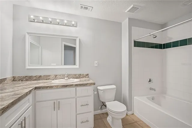 a bathroom with a sink toilet vanity and shower