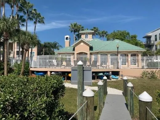 a front view of a house with a garden and swimming pool