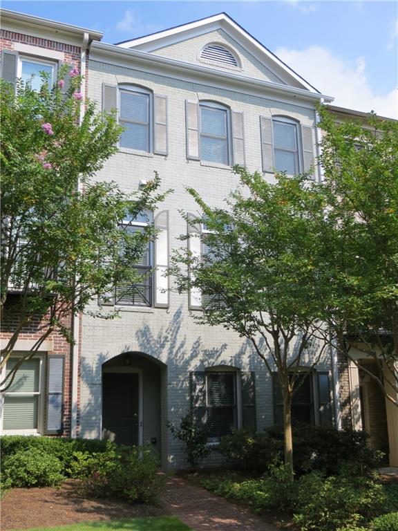 a front view of a house with yard and parking