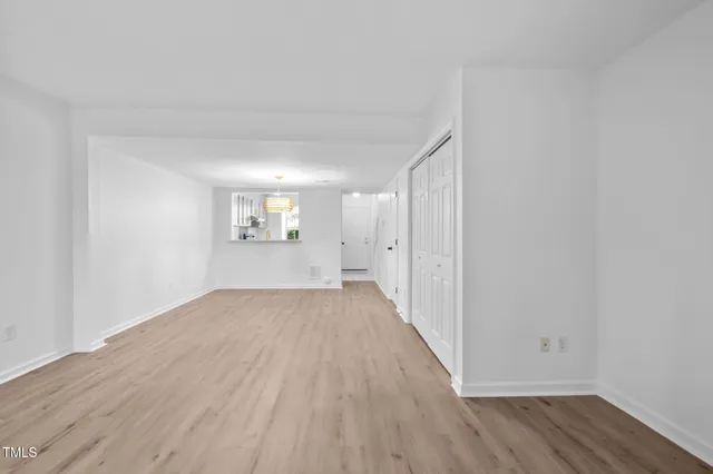 wooden floor in an empty room with a window
