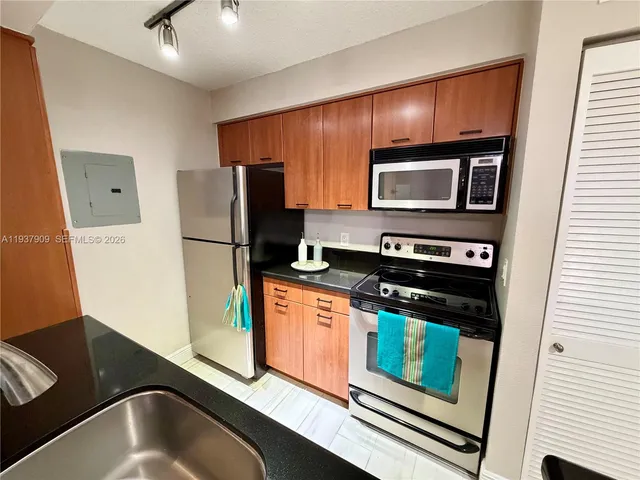a kitchen with a refrigerator stove and microwave