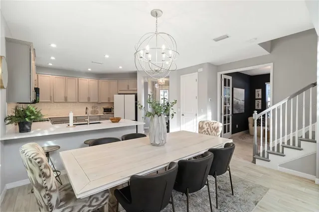 a kitchen with a refrigerator a stove and a cabinets