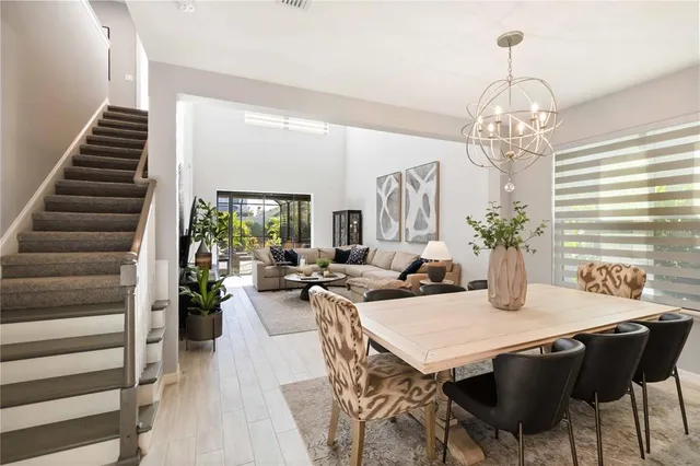 a living room with furniture a potted plant and a window