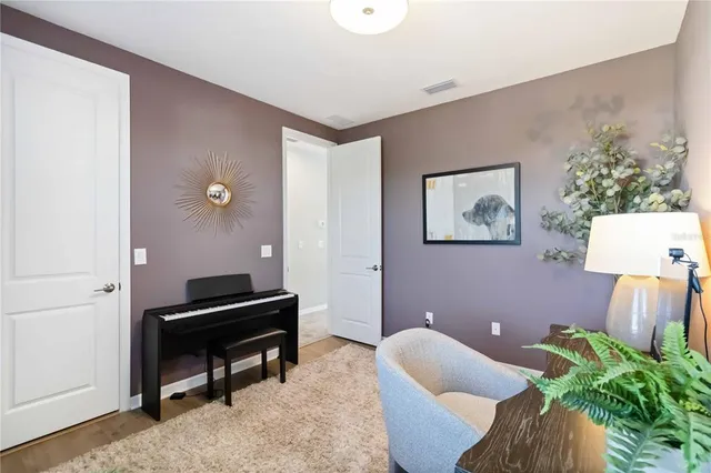 a bathroom with a granite countertop toilet a sink a mirror a shower curtain