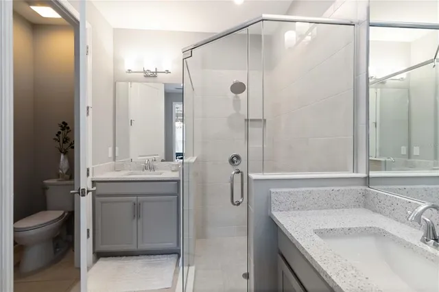 a bedroom with a bed dresser and a flat screen tv