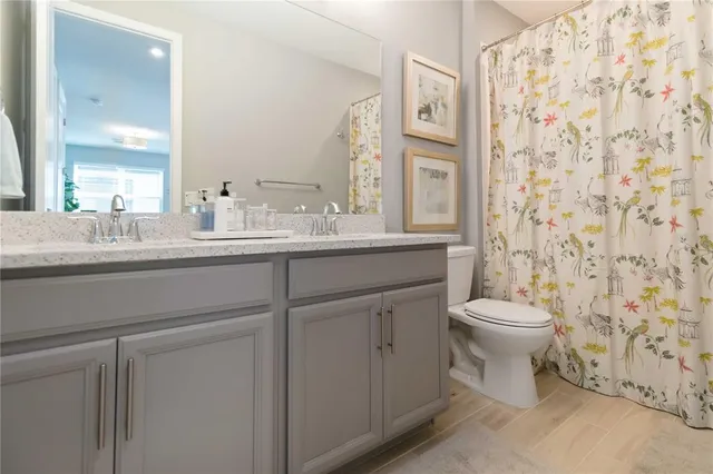 a living room with patio furniture and a potted plant