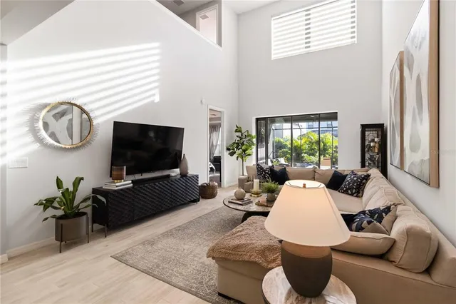 a living room with fireplace furniture and a potted plant