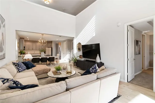 a view of a dining room with furniture and chandelier