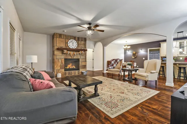 a living room with furniture a flat screen tv and a fireplace