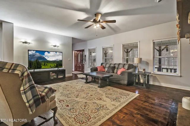 a living room with furniture and wooden floor