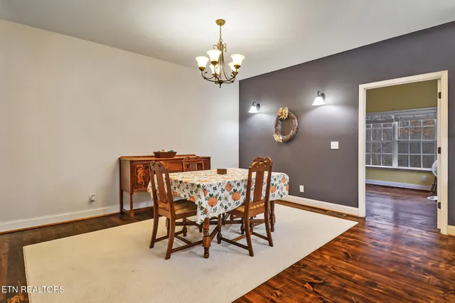a bedroom with a bed and a lamp on the dresser