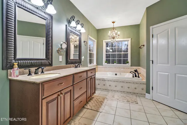 a view of a hallway with closet and bathroom