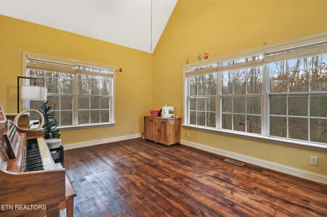a view of a room with wooden floor and a window